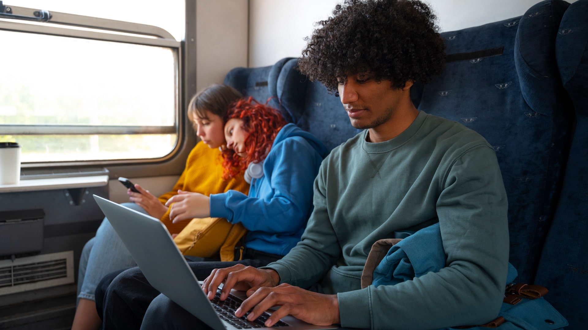 Man working at his laptop on train