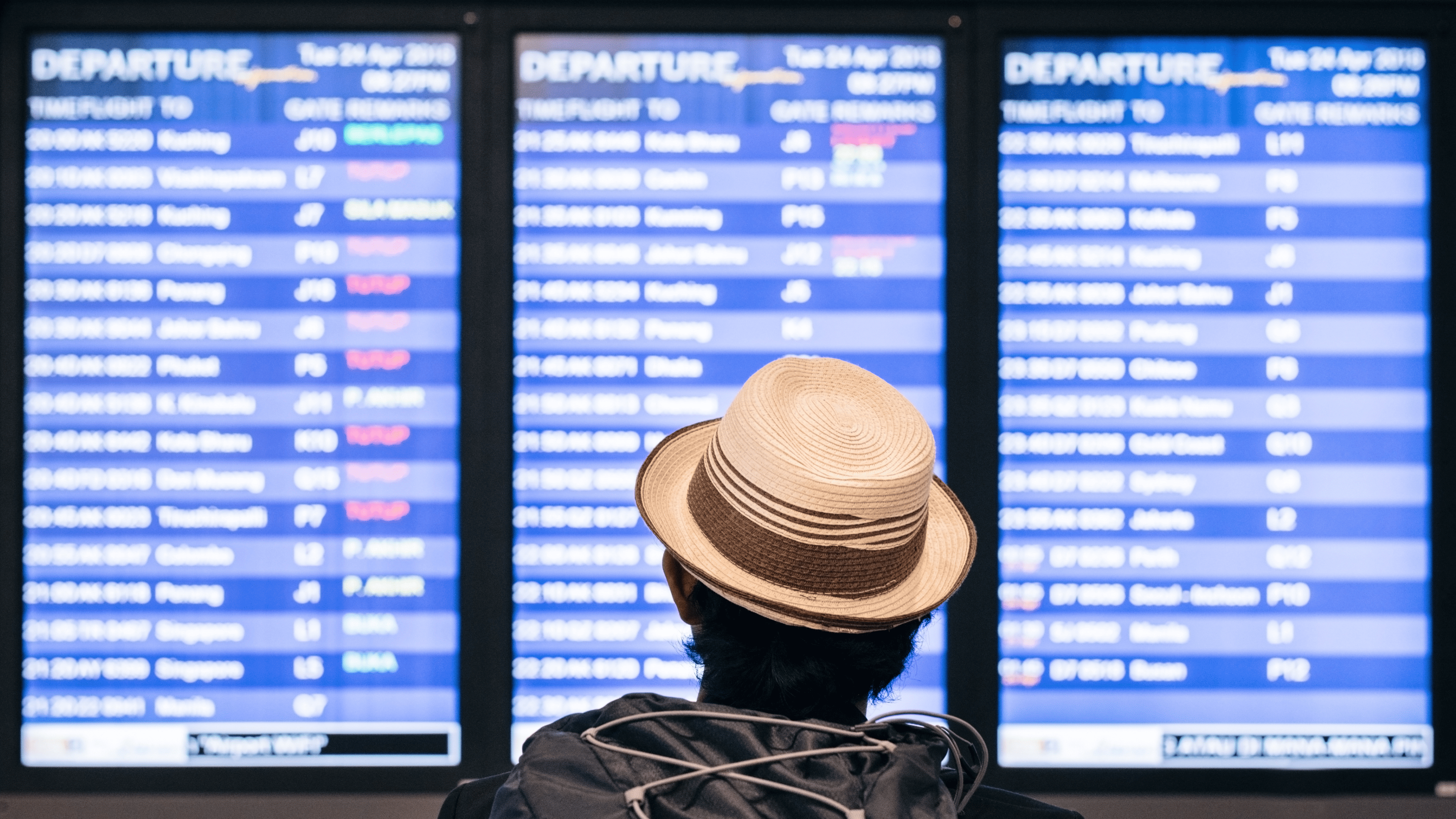 man looking at the timetable at the airport
