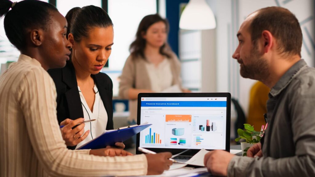 Diverse team analyzing charts in a meeting room